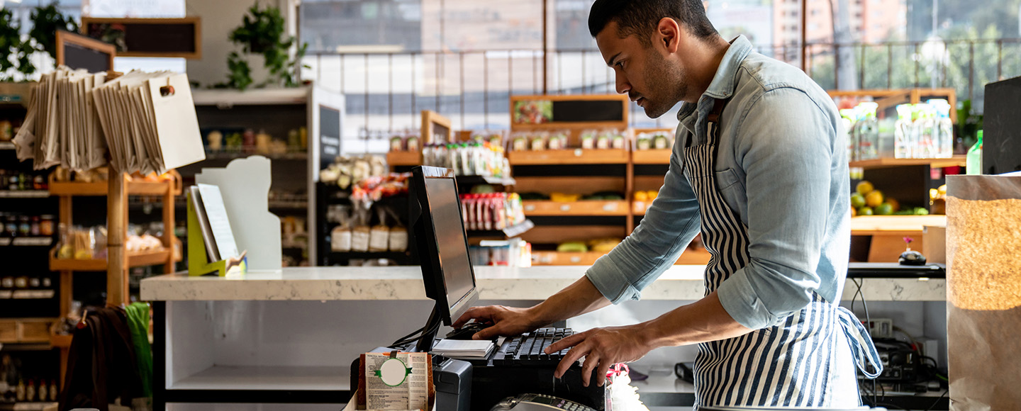 person checking cash register at store