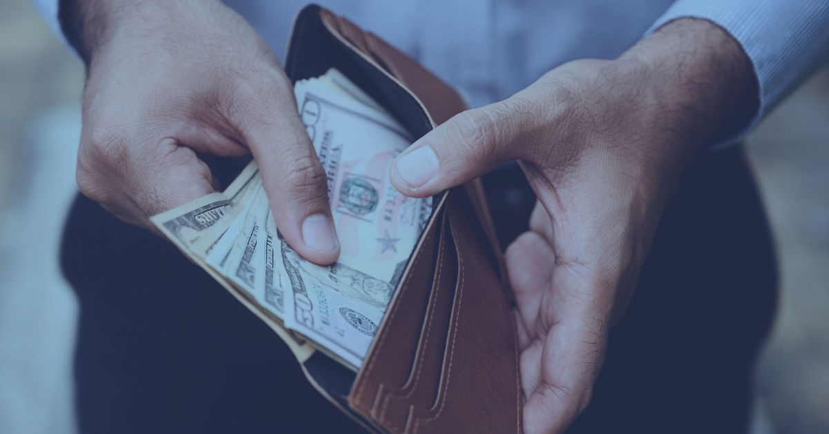 Man pulling cash from wallet