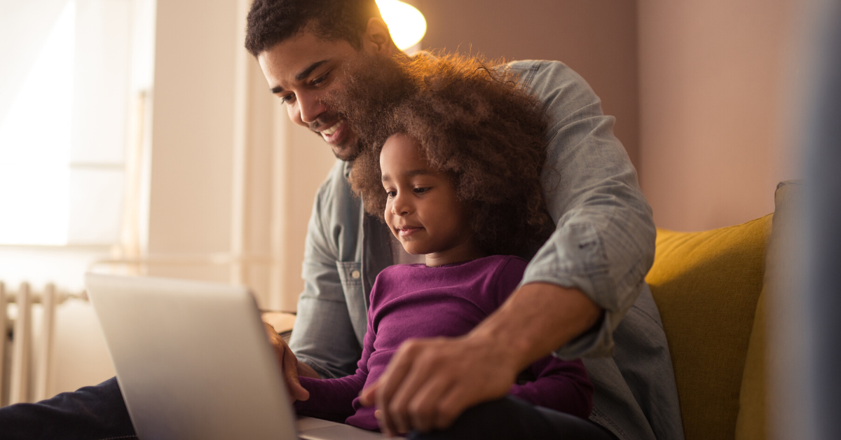 man and daughter at laptop