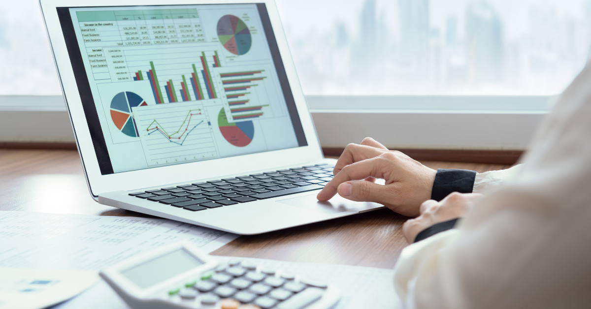 A person sitting at a desk reviewing business expense reports